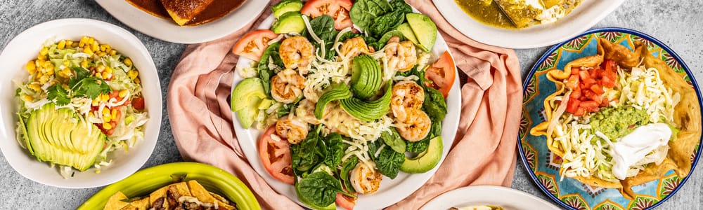 Three fresh tacos with various fillings